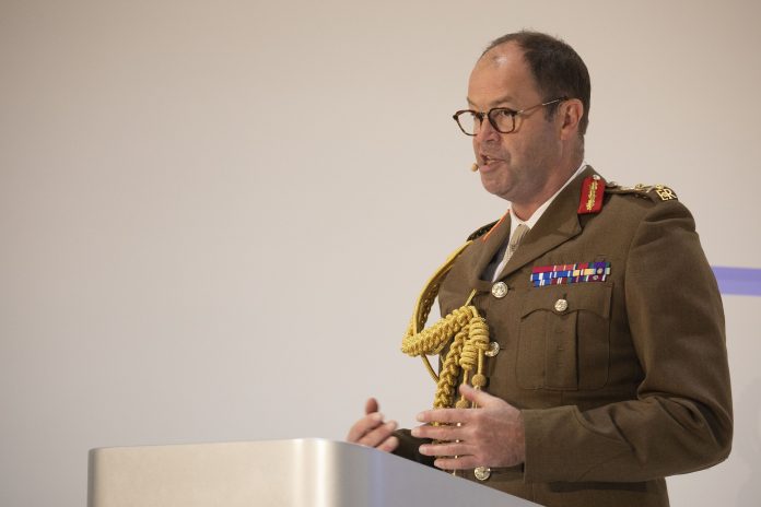 Commander of Strategic Command General Sir Patrick Sanders delivering a speech at DSEI 2021.
